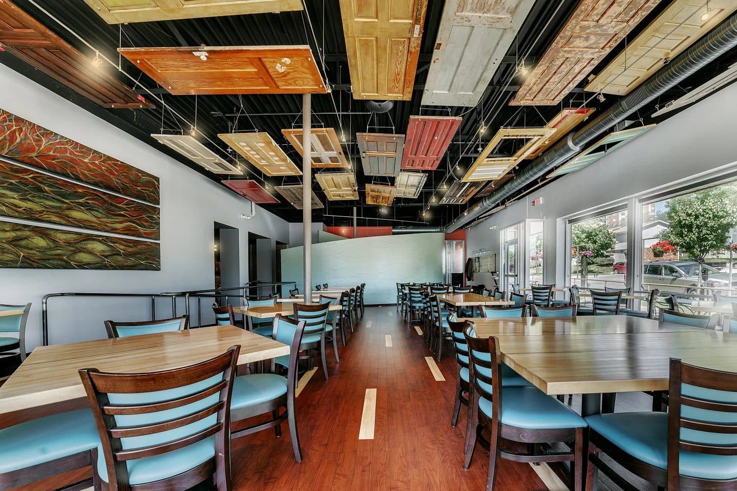 Alba dining room with reclaimed doors on the ceiling