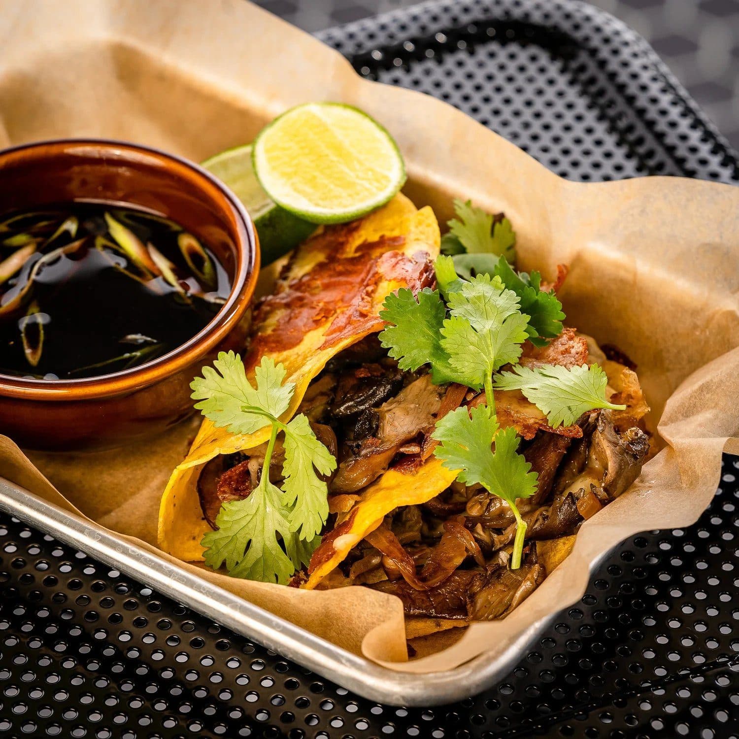 Tacos with cilantro and lime at Bar Nico