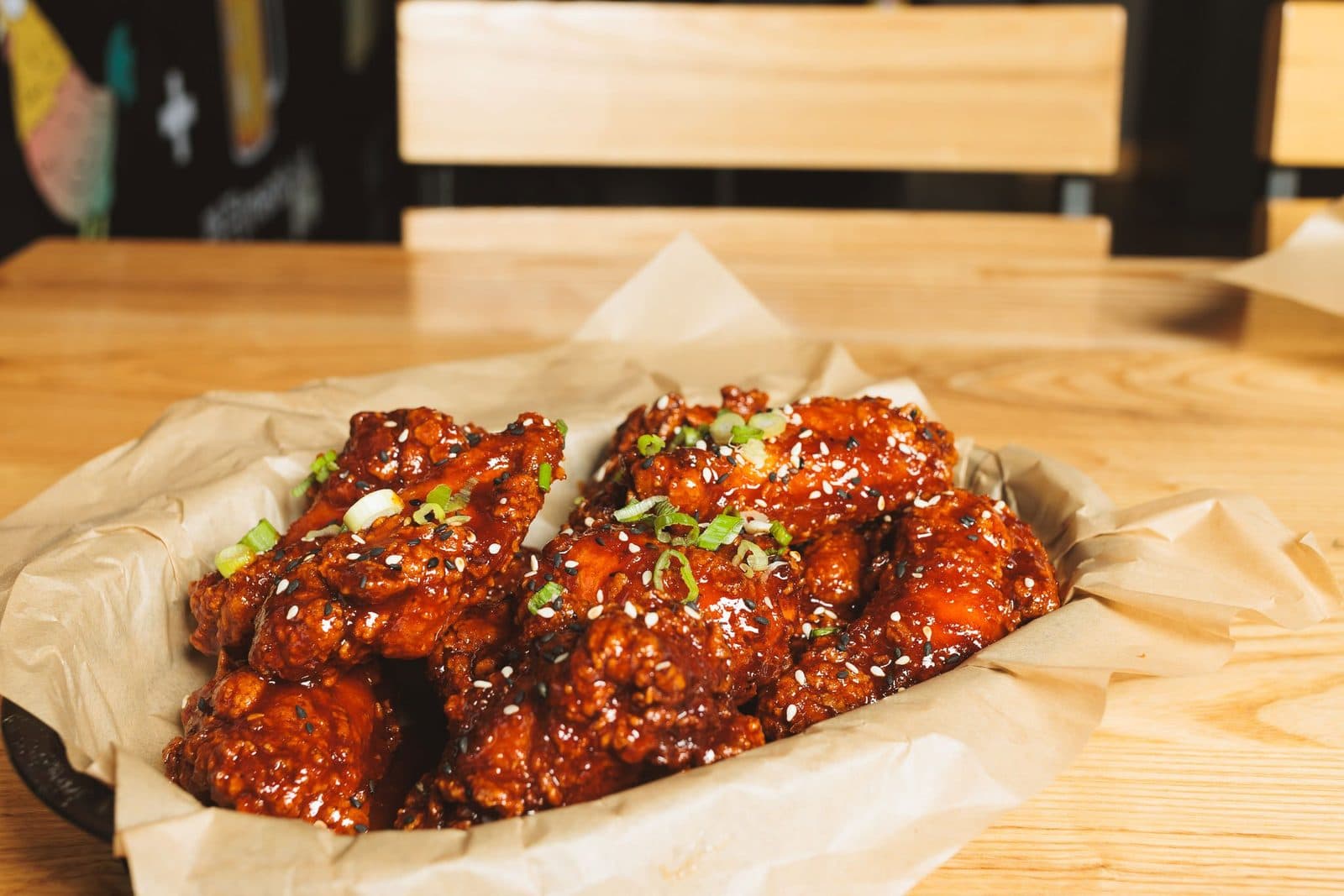 Double-fried Korean fried chicken glazed in sauce with sesame and scallions at Chikin Lickin