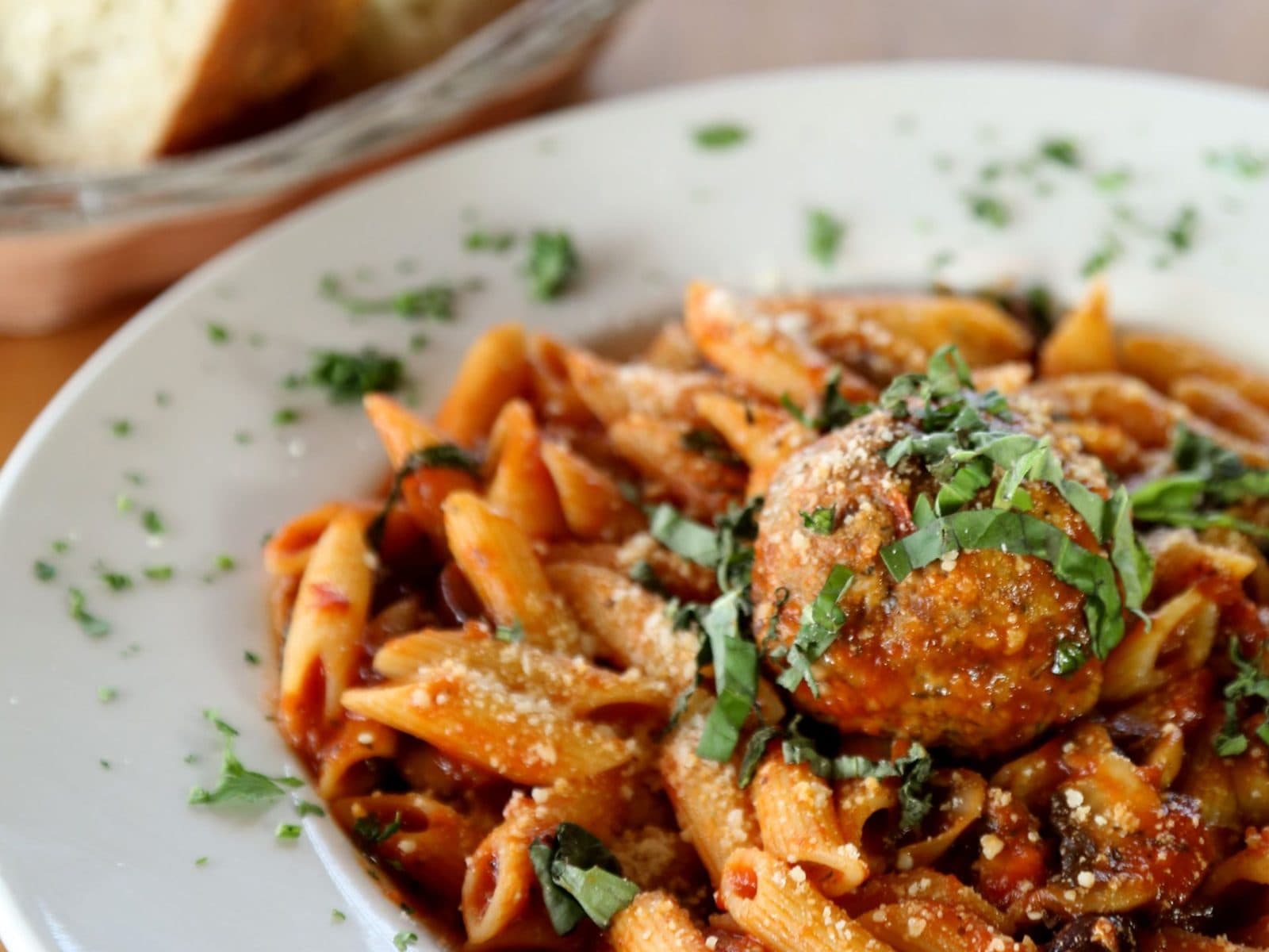 Pasta topped with meatballs and fresh herbs at Christopher's