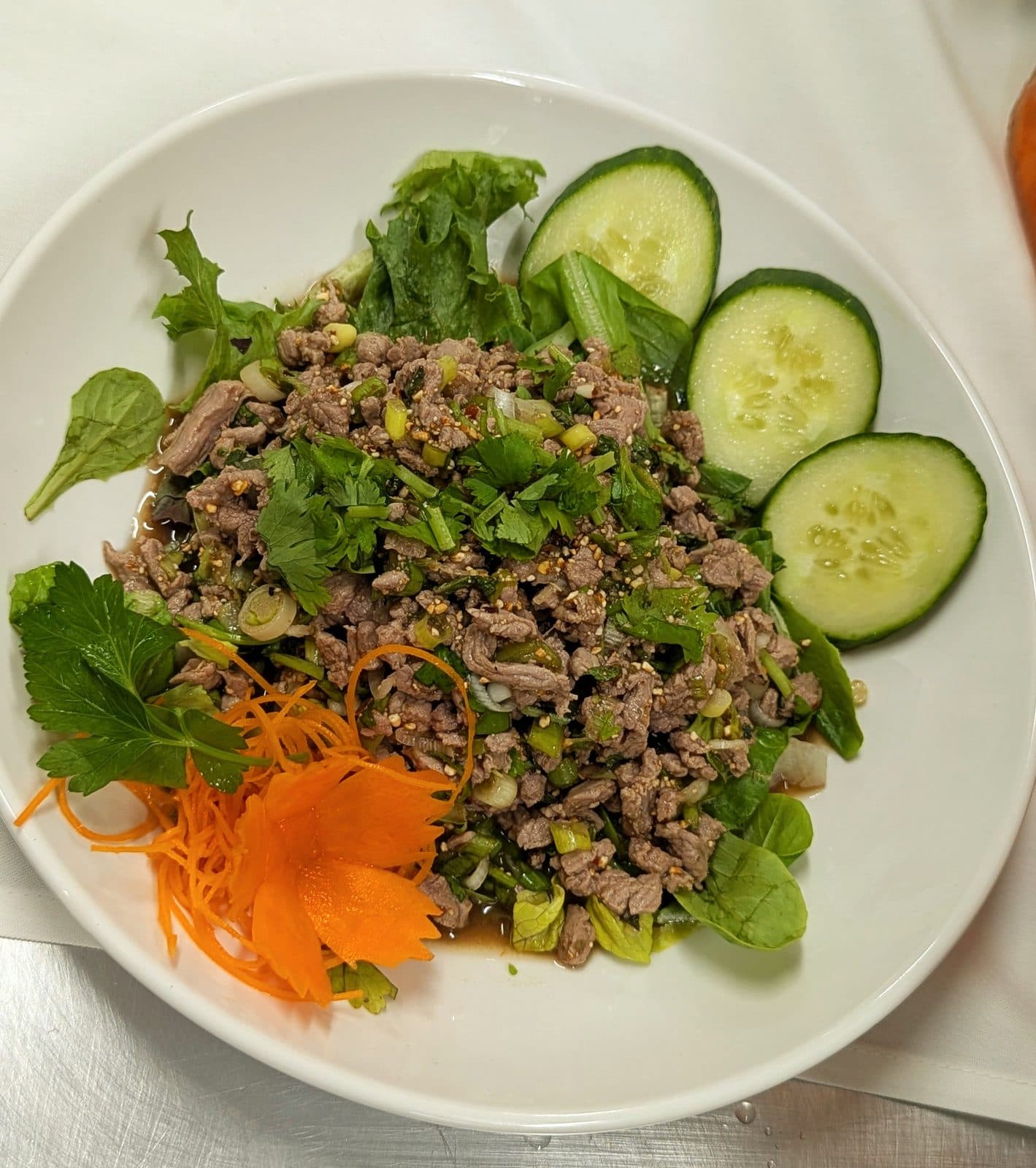 Laab, a Lao minced meat salad with herbs and cucumber, at Hoang Khao