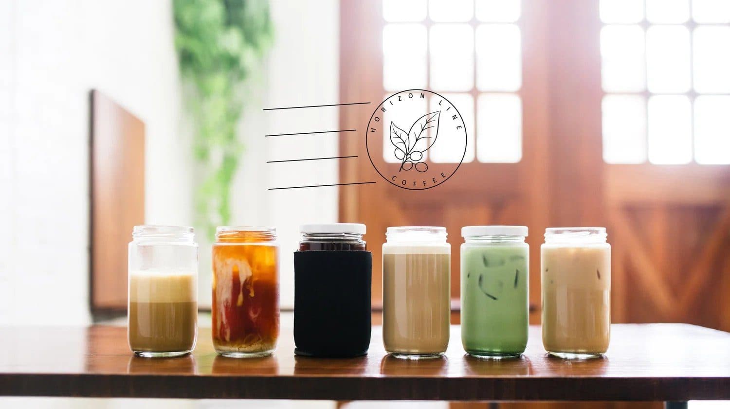 Glass jars of iced coffee drinks lined up at Horizon Line