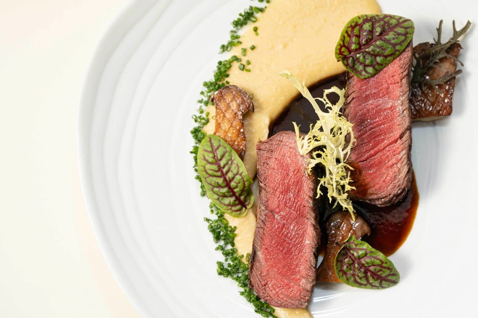 Sliced beef with garden greens and sauce at Oak Park