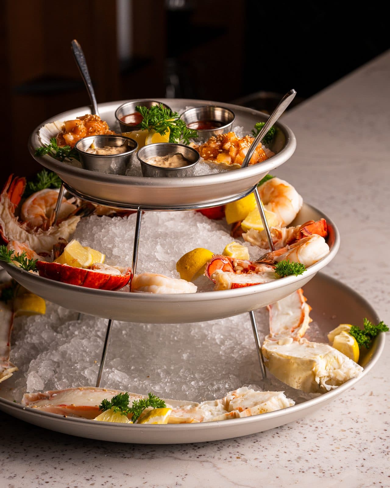 Three-tier seafood tower on ice with lobster, shrimp, and oysters at Prime and Providence