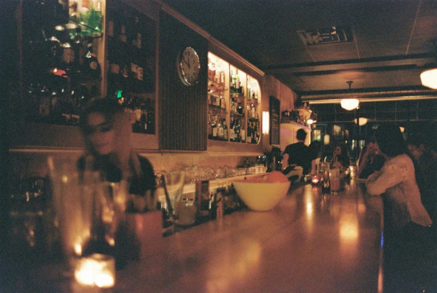 The candlelit bar at The Bartender's Handshake