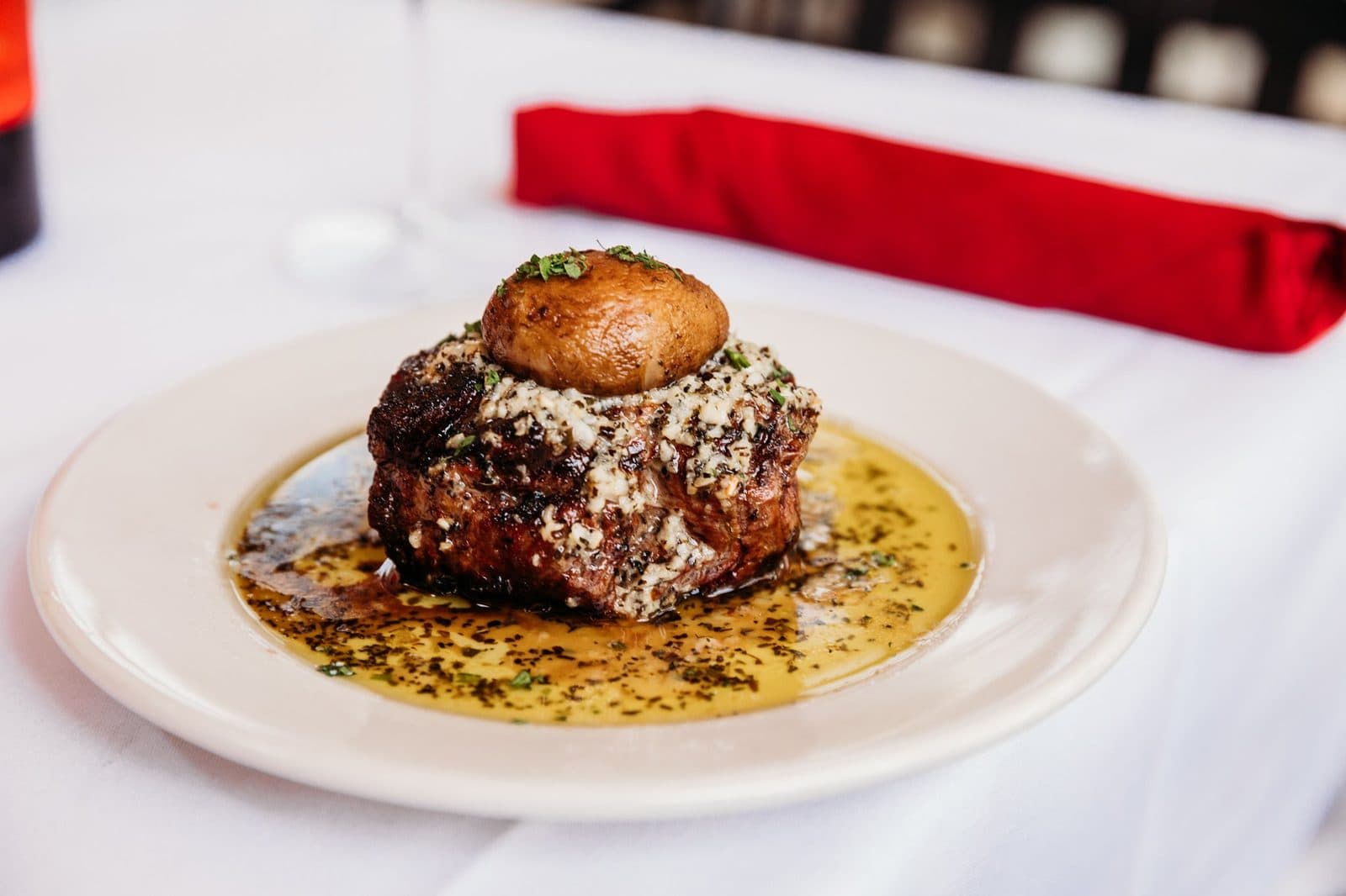 A steak plated on a white tablecloth at Tursi's Latin King