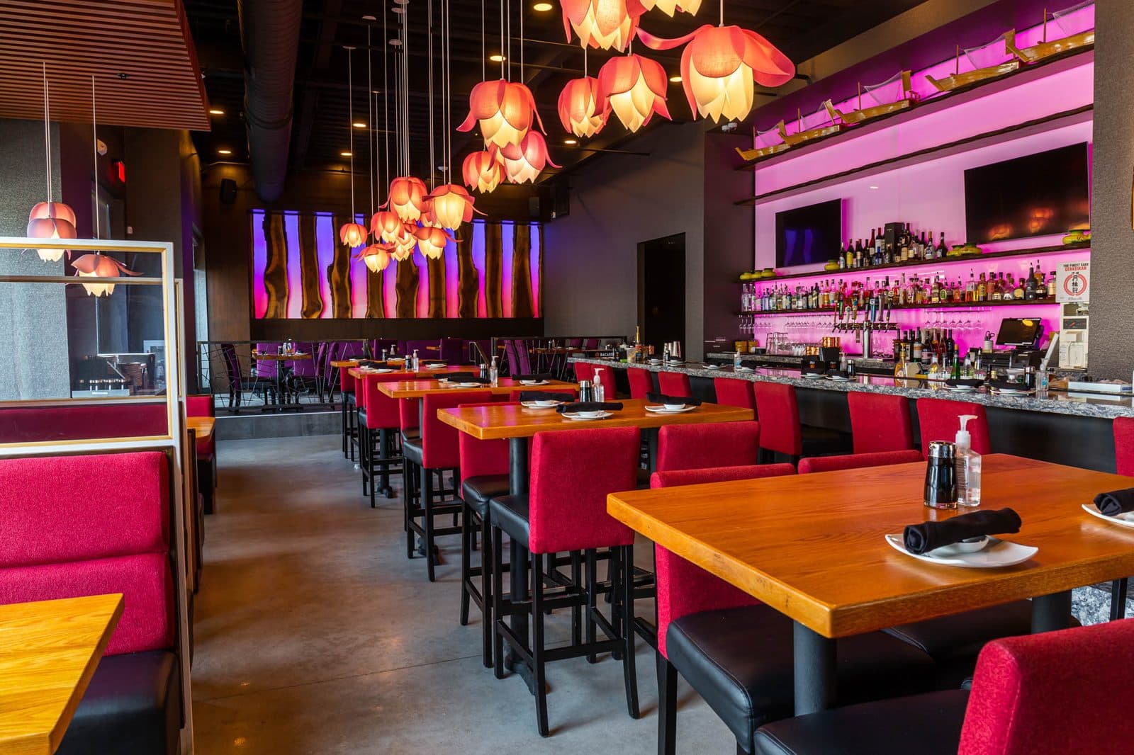 Dining room with red booths and lotus pendant lamps at Wasabi Ankeny
